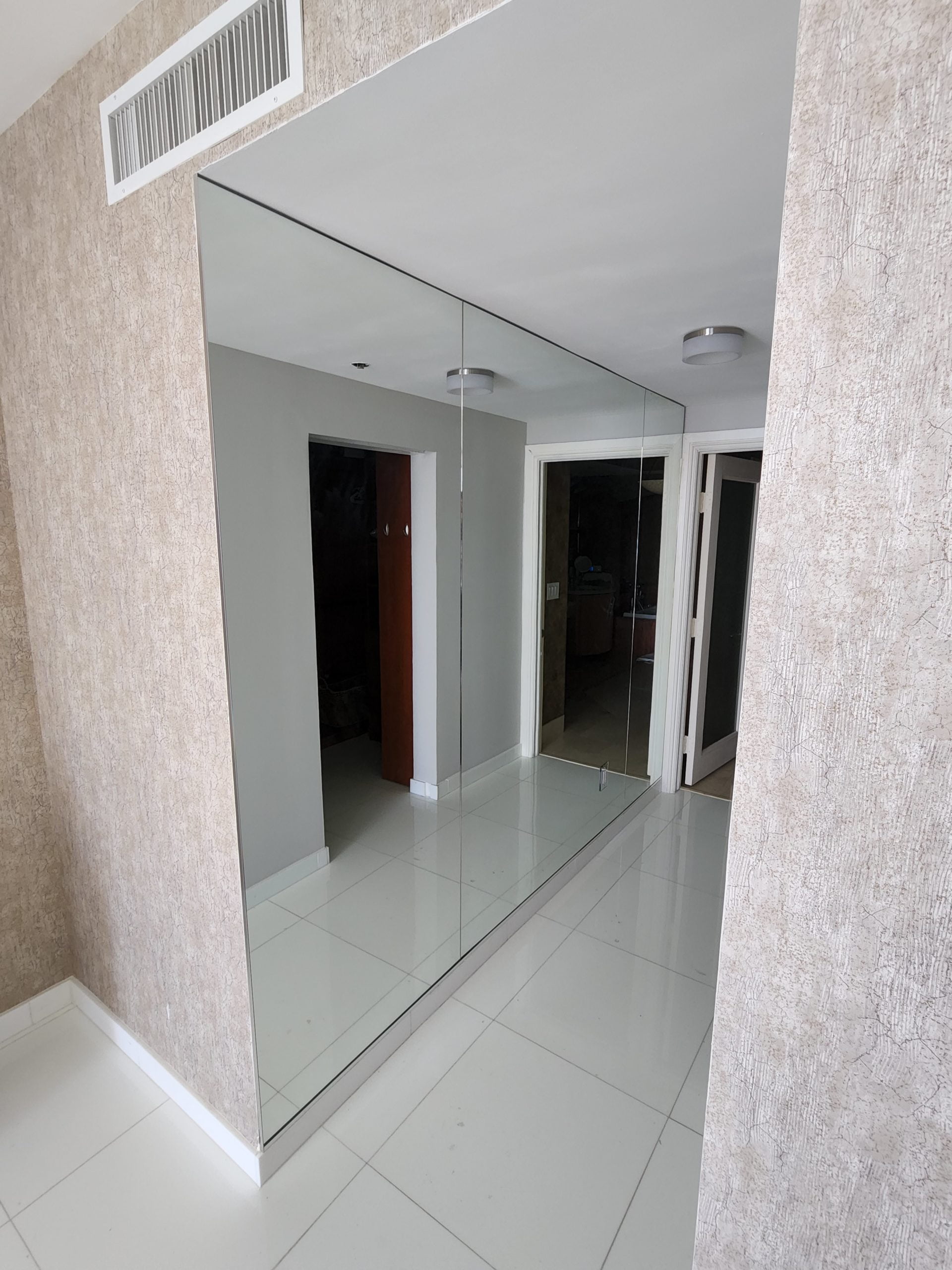 hallway with a large mirrored wall