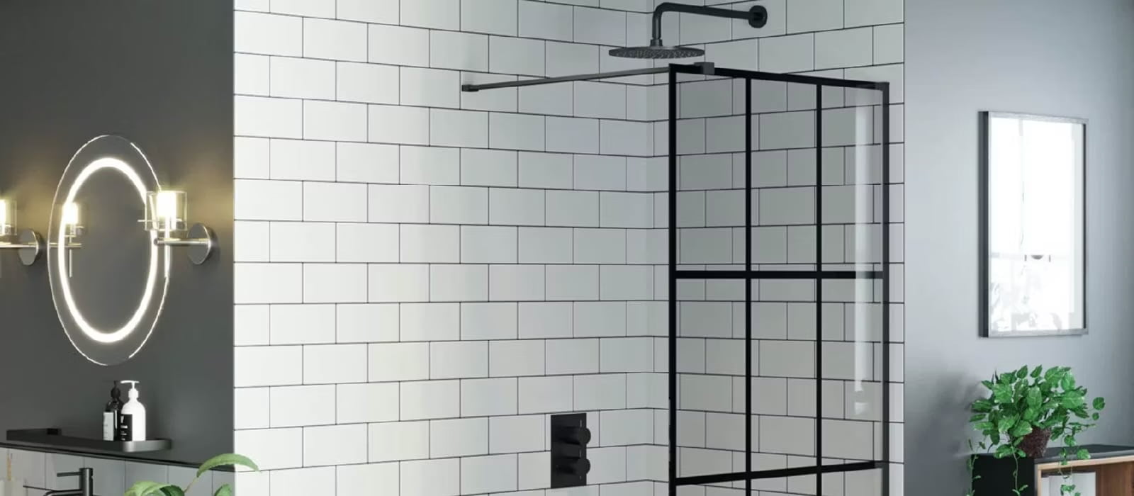 A sleek modern bathroom featuring a walk-in shower with a glass door framed in black