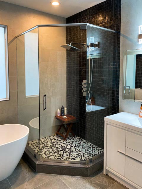 A modern bathroom featuring a glass-enclosed walk-in shower