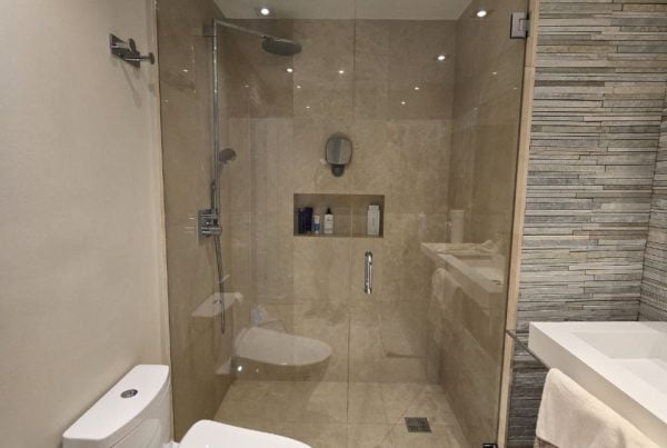 Glass shower doors in a stylish bathroom.