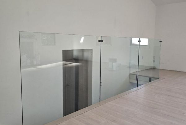 Transparent glass railing on the second floor in a modern interior