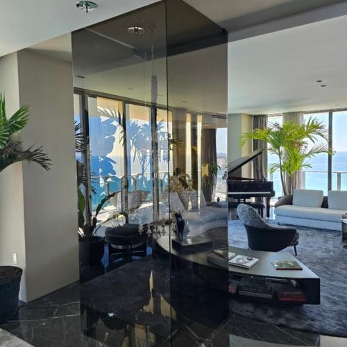 Colored mirrored panels in a living room with sea views and a modern interior